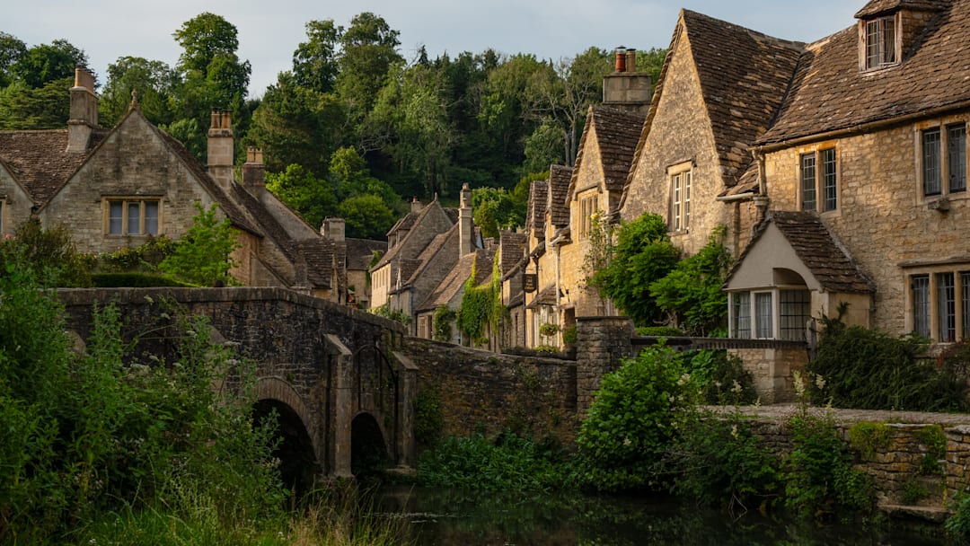 Honey-colored houses of Castle Combe, located in the Cotswolds. Honey-colored houses of Castle Combe, located in the Cotswolds.