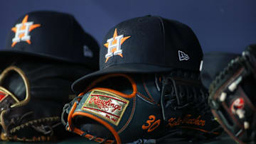 Apr 21, 2023; Atlanta, Georgia, USA; A detailed view of a Houston Astros hat and glove in the dugout against the Atlanta Braves in the fifth inning at Truist Park. Mandatory Credit: Brett Davis-Imagn Images
