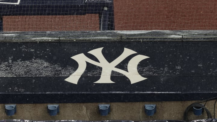 Aug 17, 2020; Bronx, New York, USA; A general view of rain falling on the  New York Yankees logo on the first base dugout roof during a rain delay in the game between the New York Yankees and the Boston Red Sox. Mandatory Credit: Vincent Carchietta-USA TODAY Sports