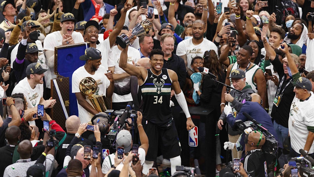 Jul 20, 2021; Milwaukee, Wisconsin, USA; Milwaukee Bucks forward Giannis Antetokounmpo (34) celebrates with the NBA Finals MVP Trophy following the game against the Phoenix Suns following game six of the 2021 NBA Finals at Fiserv Forum. Mandatory Credit: Jeff Hanisch-Imagn Images