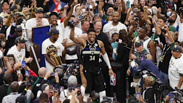 Jul 20, 2021; Milwaukee, Wisconsin, USA; Milwaukee Bucks forward Giannis Antetokounmpo (34) celebrates with the NBA Finals MVP Trophy following the game against the Phoenix Suns following game six of the 2021 NBA Finals at Fiserv Forum. Mandatory Credit: Jeff Hanisch-Imagn Images