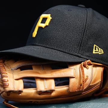 Jun 30, 2021; Denver, Colorado, USA; A general view of a Pittsburgh Pirates glove and hat in the eighth inning against the Colorado Rockies at Coors Field. Mandatory Credit: Isaiah J. Downing-Imagn Images