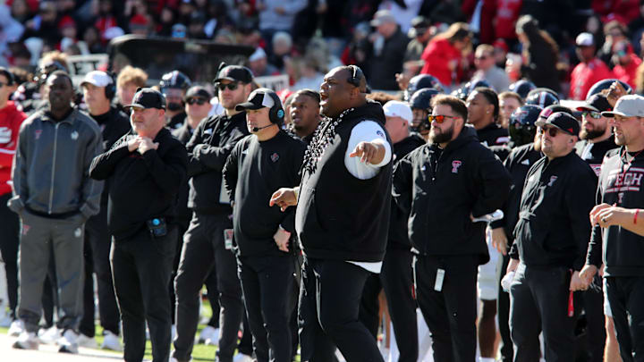 Nov 30, 2024; Lubbock, Texas, USA;  Texas Tech Red Raiders associate head coach Kenny Perry, head coach Joey McGuire and defensive line coach Zarnell Fitch on the sidelines in the first half during the game against the West Virginia Mountaineers at Jones AT&T Stadium and Cody Campbell Field. Mandatory Credit: Michael C. Johnson-Imagn Images
