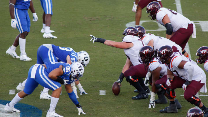 Oct 3, 2020; Durham, North Carolina, USA; The Duke Blue Devils defensive line, left, lines up against the Virginia Tech Hokies offensive line in the first half at Wallace Wade Stadium. Mandatory Credit: Nell Redmond-USA TODAY Sports