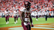 Sep 27, 2025; Raleigh, North Carolina, USA;  Virginia Tech Hokies running back Marcellous Hawkins (27) makes a touchdown and celebrates during the first half of the game against North Carolina State Wolfpack at Carter-Finley Stadium. Mandatory Credit: Jaylynn Nash-Imagn Images