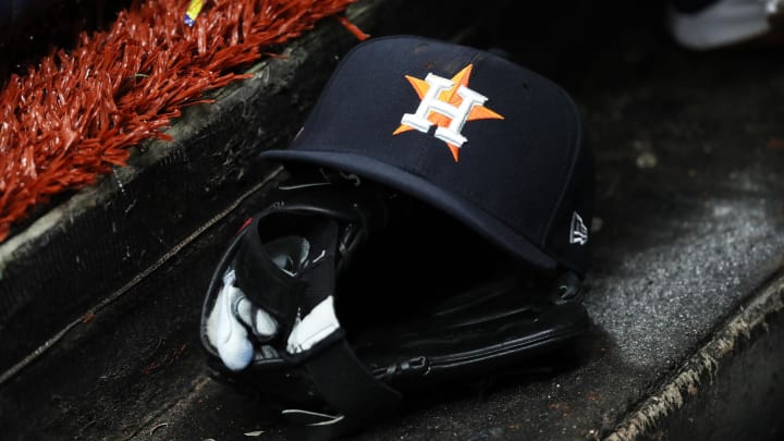 Mar 28, 2019; St. Petersburg, FL, USA; A detail view of a Houston Astros baseball hat and glove lay in the dugout at Tropicana Field.