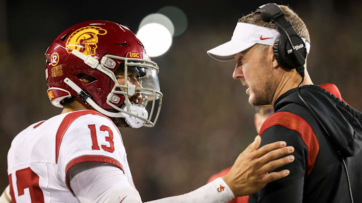 Bears QB Caleb Williams talks with USC coach Lincoln Riley during a USC game last season.