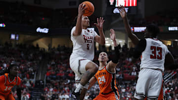Jan 26, 2025; Lubbock, Texas, USA;  Texas Tech Red Raiders forward Darrion Williams (5) drives to the basket against Oklahoma State Cowboys forward Patrick Suemnick (24) in the first half at United Supermarkets Arena. Mandatory Credit: Michael C. Johnson-Imagn Images