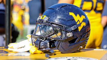 Aug 30, 2025; Morgantown, West Virginia, USA; A West Virginia Mountaineers football helmet is seen along the sidelines during the fourth quarter against the Robert Morris Colonials at Milan Puskar Stadium. Mandatory Credit: Ben Queen-Imagn Images