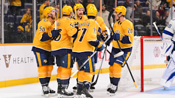 Oct 28, 2025; Nashville, Tennessee, USA;  Nashville Predators left wing Filip Forsberg (9) celebrates with his teammates after scoring a goal against the Tampa Bay Lightning during the third period at Bridgestone Arena. Mandatory Credit: Steve Roberts-Imagn Images