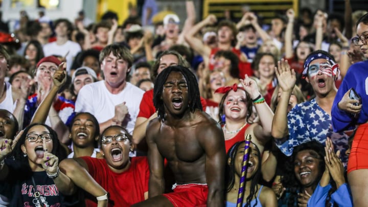 The Louisville Male High student section roars as the Bulldogs rolled past Trinity in 2023 Kentucky high school football. 