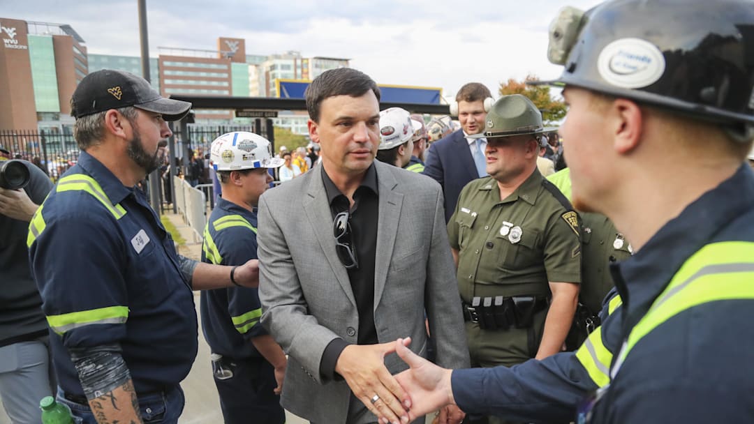 Oct 12, 2024; Morgantown, West Virginia, USA; West Virginia Mountaineers head coach Neal Brown shakes the hands of coal miners who led the team into the stadium before their game against the Iowa State Cyclones at Mountaineer Field at Milan Puskar Stadium. Mandatory Credit: Ben Queen-Imagn Images