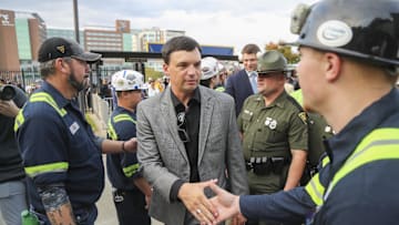 Oct 12, 2024; Morgantown, West Virginia, USA; West Virginia Mountaineers head coach Neal Brown shakes the hands of coal miners who led the team into the stadium before their game against the Iowa State Cyclones at Mountaineer Field at Milan Puskar Stadium. Mandatory Credit: Ben Queen-Imagn Images