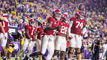 Nov 9, 2024; Baton Rouge, Louisiana, USA;  Alabama Crimson Tide quarterback Jalen Milroe (4) tosses the football to the referee after scoring a touchdown against the LSU Tigers during the second half at Tiger Stadium. Mandatory Credit: Stephen Lew-Imagn Images
