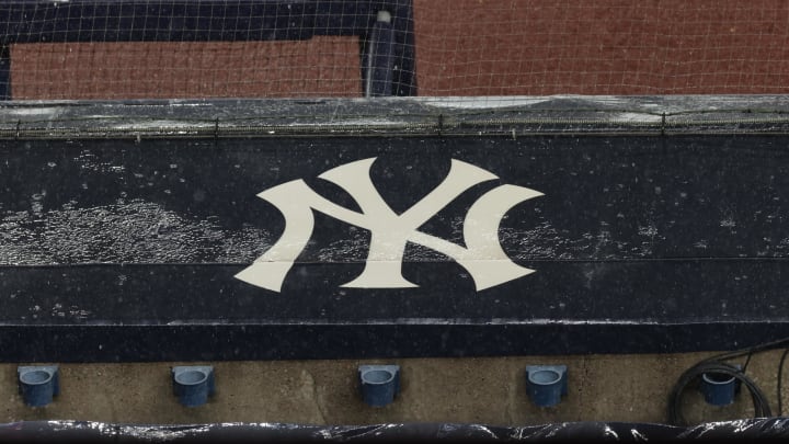 Aug 17, 2020; Bronx, New York, USA; A general view of rain falling on the  New York Yankees logo on the first base dugout roof during a rain delay in the game between the New York Yankees and the Boston Red Sox. Mandatory Credit: Vincent Carchietta-USA TODAY Sports