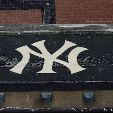 Aug 17, 2020; Bronx, New York, USA; A general view of rain falling on the  New York Yankees logo on the first base dugout roof during a rain delay in the game between the New York Yankees and the Boston Red Sox. Mandatory Credit: Vincent Carchietta-Imagn Images