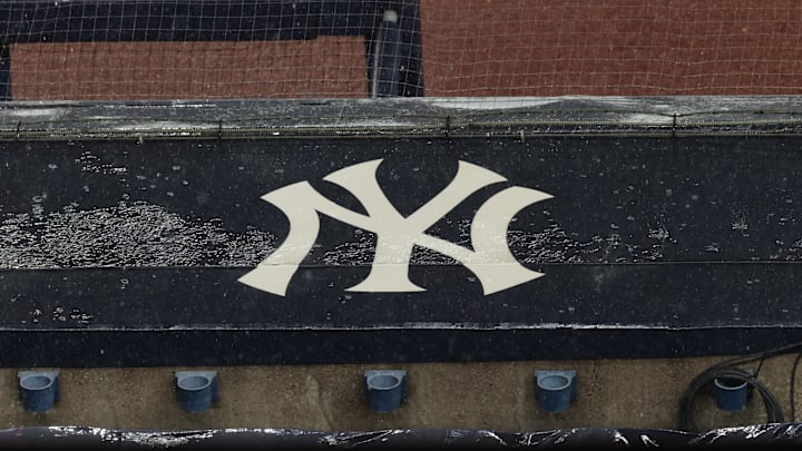 Aug 17, 2020; Bronx, New York, USA; A general view of rain falling on the  New York Yankees logo on the first base dugout roof during a rain delay in the game between the New York Yankees and the Boston Red Sox. Mandatory Credit: Vincent Carchietta-Imagn Images