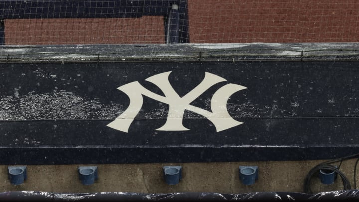 Aug 17, 2020; Bronx, New York, USA; A general view of rain falling on the  New York Yankees logo on the first base dugout roof during a rain delay in the game between the New York Yankees and the Boston Red Sox. Mandatory Credit: Vincent Carchietta-USA TODAY Sports