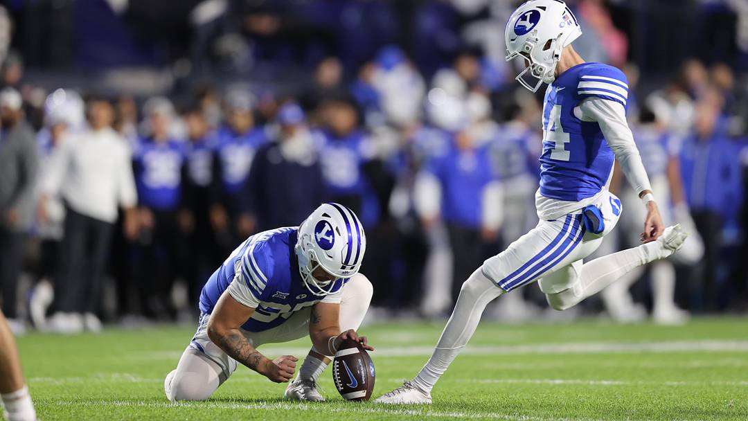 Brigham Young Cougars place kicker Will Ferrin (44) kicks an extra point against the Oklahoma State Cowboys during the third quarter at LaVell Edwards Stadium.