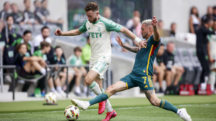 Austin FC defender Jon Gallagher (17) attempts to shield off LA Galaxy midfielder Diego Fagundez (7) 
