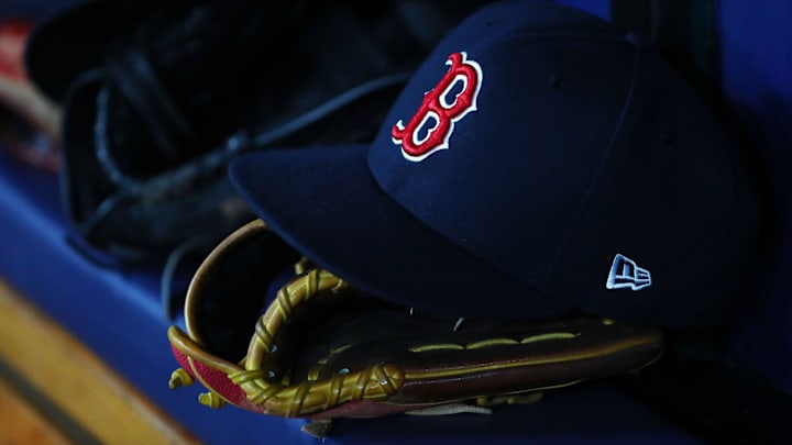 Jul 22, 2019; St. Petersburg, FL, USA; A detail view of Boston Red Sox hat and glove laying in the dugout at Tropicana Field. Mandatory Credit: Kim Klement-Imagn Images