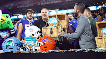 Dec 20, 2024; Tampa, FL, USA; Florida Gators head coach Billy Napier is presented the Gasparilla Bowl championship trophy after the win against the Tulane Green Wave at Raymond James Stadium. Mandatory Credit: Kim Klement Neitzel-Imagn Images