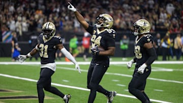 Oct 13, 2024; New Orleans, Louisiana, USA;  New Orleans Saints defensive end Cameron Jordan (94) reacts to intercepting the pass of Tampa Bay Buccaneers quarterback Baker Mayfield (6) during the first half at Caesars Superdome. Mandatory Credit: Stephen Lew-Imagn Images