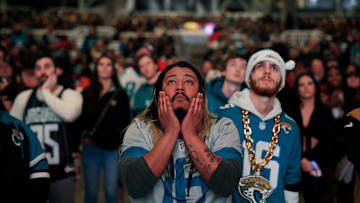 Jacksonville Jaguars fans Griffin Lasch, center, and Garrett Roberson, right, react to costly mistakes during the second half Saturday, Jan 21, 2023 at TIAA Bank Field's Dream Finders Homes Flex Field at Daily's Place in Jacksonville, Fla. 