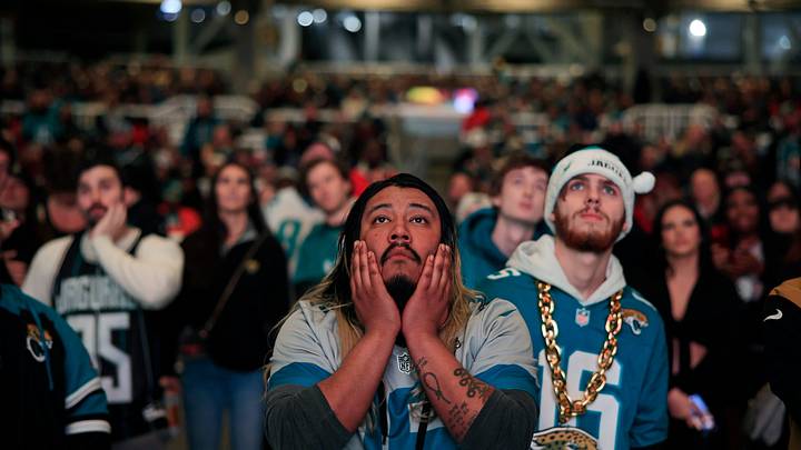 Jacksonville Jaguars fans Griffin Lasch, center, and Garrett Roberson, right, react to costly mistakes during the second half Saturday, Jan 21, 2023 at TIAA Bank Field's Dream Finders Homes Flex Field at Daily's Place in Jacksonville, Fla. 