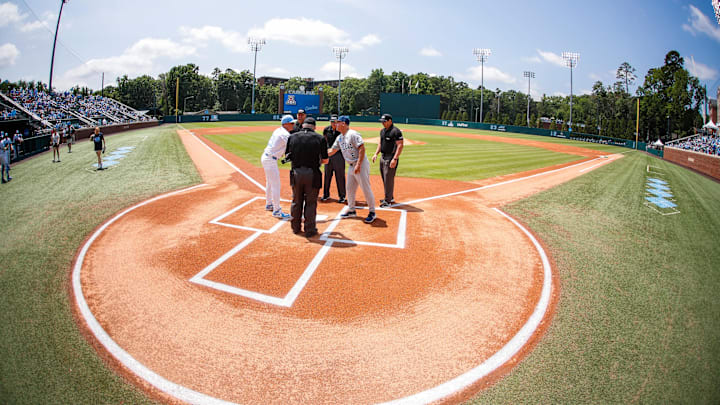 Jun 8, 2025; Chapel Hill, NC, USA; North Carolina Head Coach Scott Forbes and Arizona Head Coach Chip Hale meet before the first inning of the Super Regionals game in Chapel Hill, North Carolina. Mandatory Credit: Jaylynn Nash-Imagn Images