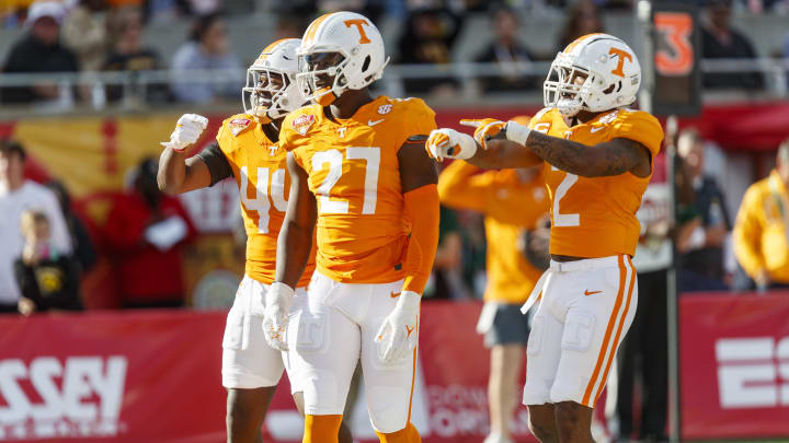 Jan 1, 2024; Orlando, FL, USA; Tennessee Volunteers defensive lineman James Pearce Jr. (27), linebacker Elijah Herring (44) and defensive back Jaylen McCollough (2) celebrate a sack against the Iowa Hawkeyes during the third quarter at Camping World Stadium. Mandatory Credit: Morgan Tencza-USA TODAY Sports