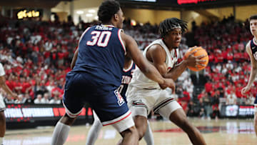 Jan 18, 2025; Lubbock, Texas, USA;  Texas Tech Red Raiders forward JT Toppin (15) keeps the ball from Arizona Wildcats forward Tobe Awaka (30) in the second half at United Supermarkets Arena. Mandatory Credit: Michael C. Johnson-Imagn Images