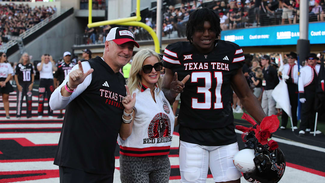 Nov 15, 2025; Lubbock, Texas, USA;  Texas Tech Red Raiders head coach Joey McGuire and wife Debbie celebrate senior day with Texas Tech Red Raiders defensive end David Bailey (31) before the game against the Central Florida Knights at Jones AT&T Stadium. Mandatory Credit: Michael C. Johnson-Imagn Images