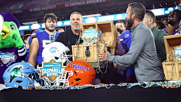 Dec 20, 2024; Tampa, FL, USA; Florida Gators head coach Billy Napier is presented the Gasparilla Bowl championship trophy after the win against the Tulane Green Wave at Raymond James Stadium. Mandatory Credit: Kim Klement Neitzel-Imagn Images