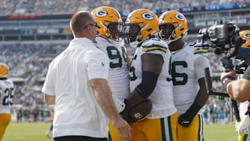 Oct 27, 2024; Jacksonville, Florida, USA; Green Bay Packers defensive lineman Devonte Wyatt (95), defensive lineman Karl Brooks (94), and defensive lineman Colby Wooden (96) celebrate a recovered fumble against the Jacksonville Jaguars during the third quarter at EverBank Stadium. Mandatory Credit: Morgan Tencza-Imagn Images