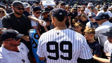 Mar 10, 2024; Tampa, Florida, USA;New York Yankees right fielder Aaron Judge (99) signs autographs