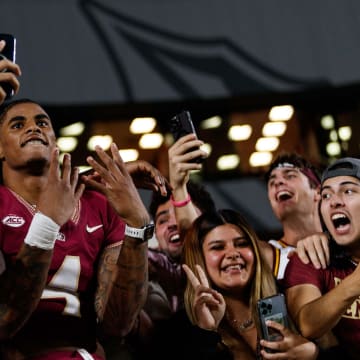 Nov 18, 2023; Tallahassee, Florida, USA; Florida State Seminoles wide receiver Keon Coleman (4) celebrates the win against the North Alabama Lions with fans at Doak S. Campbell Stadium. Mandatory Credit: Morgan Tencza-USA TODAY Sports