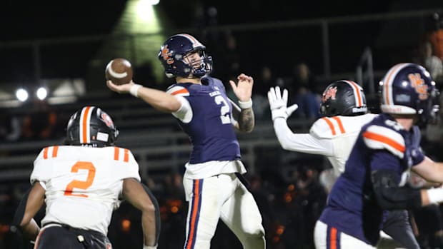 Nashville Christian quarterback Jared Curtis (2) throws the ball down field as Fayetteville's defense applies pressure in the