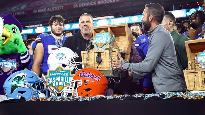 Dec 20, 2024; Tampa, FL, USA; Florida Gators head coach Billy Napier is presented the Gasparilla Bowl championship trophy after the win against the Tulane Green Wave at Raymond James Stadium. Mandatory Credit: Kim Klement Neitzel-Imagn Images