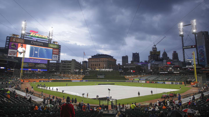 Jun 13, 2023; Detroit, Michigan, USA; The Detroit Tigers grounds crew works to put the tarp on the field during a rain delay at Comerica Park. Mandatory Credit: Brian Bradshaw Sevald-USA TODAY Sports