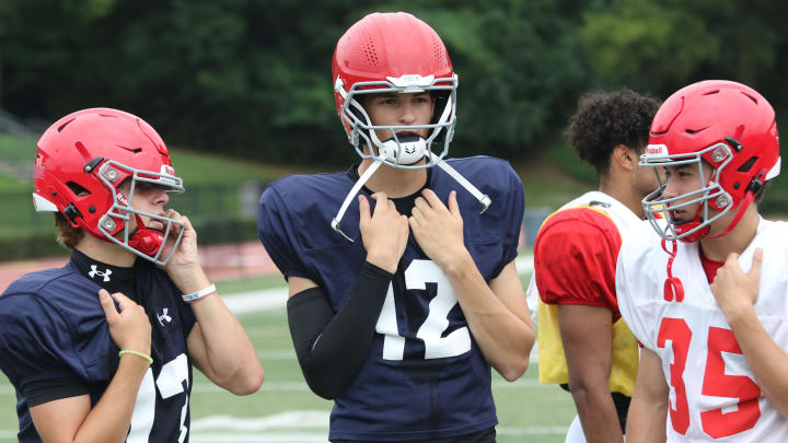 Brentwood Academy quarterback George MacIntyre (12) stands with teammates during the team's morning practice session Monday, July 29, 2024 at Brentwood Academy in Brentwood, Tennessee.