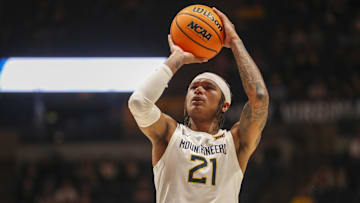 Feb 20, 2024; Morgantown, West Virginia, USA; West Virginia Mountaineers guard RaeQuan Battle (21) shoots a free throw during the second half against the UCF Knights at WVU Coliseum. Mandatory Credit: Ben Queen-Imagn Images