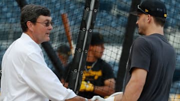 Sep 30, 2023; Pittsburgh, Pennsylvania, USA;  Pittsburgh Pirates owner Robert Nutting (left) shakes hands with left fielder Bryan Reynolds (right) at the batting cage before the game against the Miami Marlins at PNC Park. Mandatory Credit: Charles LeClaire-Imagn Images