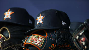 Apr 21, 2023; Atlanta, Georgia, USA; A detailed view of a Houston Astros hat and glove in the dugout against the Atlanta Braves in the fifth inning at Truist Park. 