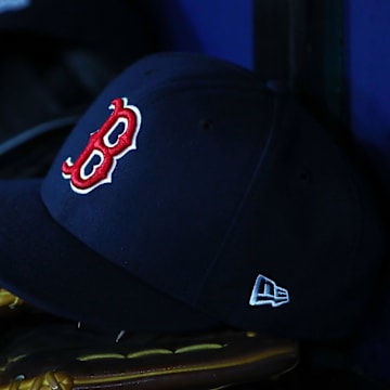 Jul 22, 2019; St. Petersburg, FL, USA; A detail view of Boston Red Sox hat and glove laying in the dugout at Tropicana Field. Mandatory Credit: Kim Klement-Imagn Images