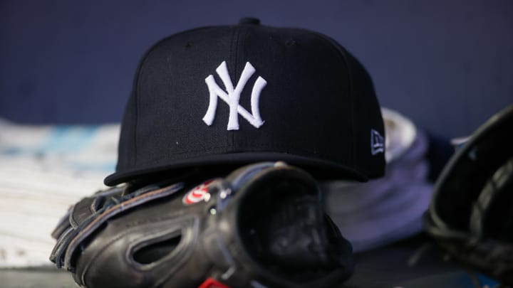 Aug 14, 2023; Atlanta, Georgia, USA; A detailed view of a New York Yankees hat and glove on the bench against the Atlanta Braves in the third inning at Truist Park. Mandatory Credit: Brett Davis-USA TODAY Sports