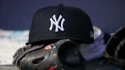 Aug 14, 2023; Atlanta, Georgia, USA; A detailed view of a New York Yankees hat and glove on the bench against the Atlanta Braves in the third inning at Truist Park. Mandatory Credit: Brett Davis-Imagn Images