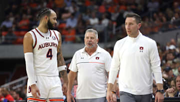 Feb 26, 2025; Auburn, Alabama, USA;  Auburn Tigers center Johni Broome (4) talks with head coach Bruce Pearl and assistant coach Steven Pearl during the second half against the Mississippi Rebels at Neville Arena. Mandatory Credit: John Reed-Imagn Images