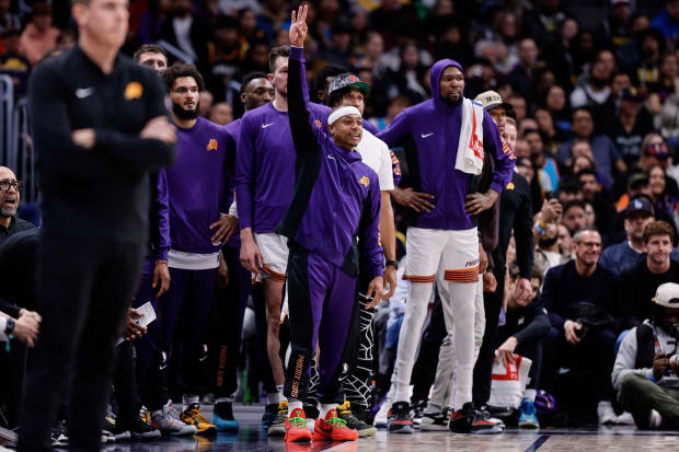 Phoenix Suns guard Isaiah Thomas (4) gestures from the bench in the fourth quarter against the Denver Nuggets.