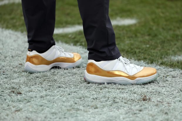 New Orleans Saints head coach Sean Payton's white and gold Air Jordan 11 sneakers.